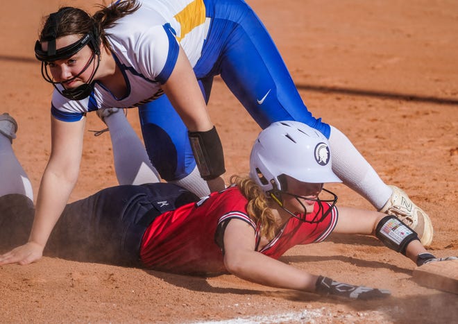 Brookfield East's Chloe Wahlen (23) slides in safe as Germantown third baseman Julia Sina (8) misses the catch during the game at Germantown, Tuesday, April 23, 2024.